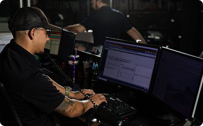 Image of a man talking on a phone and using a computer. Image of a man talking on a phone and using a computer.