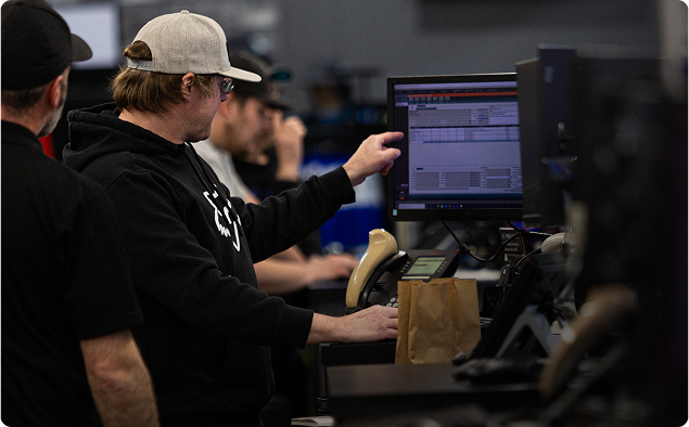 Lightspeed employees use computer monitors on a store floor. Lightspeed employees use computer monitors on a store floor.