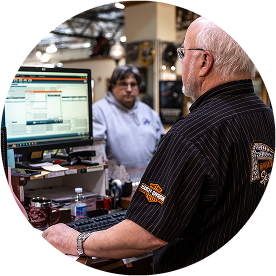 Image of an employee helping a customer at a computer.